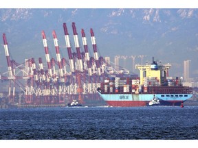 In this Oct. 8, 2018, photo, tugboats move a container ship to the dockyard of a seaport in Qingdao in eastern China's Shandong province. Customs data on Friday, Oct. 12, 2018 showed China's trade surplus with the United States widened to a record $34.1 billion September as exports to the U.S. market rose by 13 percent over a year earlier despite a worsening tariff war. (Chinatopix via AP)