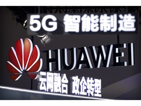 In this Sept. 26, 2018, photo, signs promoting 5G wireless technology from Chinese technology firm Huawei are displayed at the PT Expo in Beijing. A spy chief said in a speech released Tuesday, Oct. 30, 2018, that Australia's critical infrastructure including electricity grids, water supplies and hospitals could not have been adequately safeguarded if Chinese-owned telecommunications giants Huawei and ZTE Corp. had been allowed to become involved in rolling out the nation's 5G network.