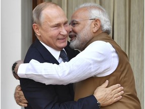 Indian Prime Minister Narendra Modi, right, hugs Russian President Vladimir Putin before their meeting in New Delhi, India, Friday, Oct. 5, 2018. Putin arrived in India on Thursday for a two-day visit during which India is expected to sign a $5 billion deal to buy Russian S-400 air defense systems despite a new U.S. law ordering sanctions on any country trading with Russia's defense and intelligence sectors.