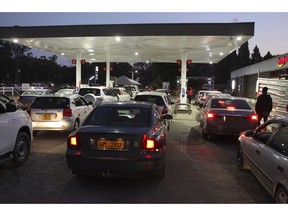 Motorists wait to fill up their tanks at a fuel station in Harare, Tuesday, Oct, 9, 2018. As Zimbabwe plunges into its worst economic crisis in a decade, gas lines are snaking for hours, prices are spiking and residents goggle as the new government insists that the country somehow has risen to middle income status.