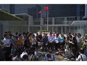 Representatives from major media associations talk to reporters after hand in a letter expressing their concerns to Hong Kong's government has refused renew the work visa of a foreign journalist outside government headquarter in Hong Kong Monday, Oct. 8, 2018. Hong Kong government has refused to renew the work visa of Victor Mallet, a senior editor of the Financial Times, in what human rights activists say is the latest sign of a deteriorating human rights situation in the semi-autonomous Chinese territory.