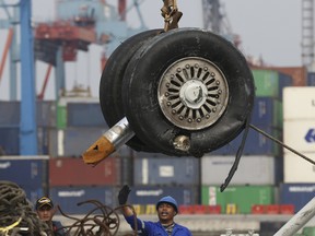 A crane moves a pair of wheels recovered from the Lion Air jet that crashed into the Java Sea for further investigation at Tanjung Priok Port in Jakarta, Indonesia.