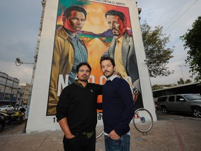 Actors Michael Pena and Diego Luna pose during the photocall to unveil a mural of Netflix's Narcos show in Mexico City.