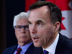 Minister of International Trade Diversification Jim Carr, left, will co-chair a two-day business conference in China with Finance Minister Bill Morneau, right, later this week.