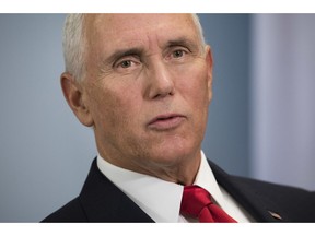 U.S. Vice President Mike Pence talks to the press during the 33rd ASEAN Summit in Singapore, Thursday, Nov. 15, 2018. America has a steadfast and enduring commitment to the Indo-Pacific region but wants cooperation, not control, U.S. Vice President Mike Pence said Thursday in comments to a Southeast Asian summit that carried a veiled swipe at China's growing influence.
