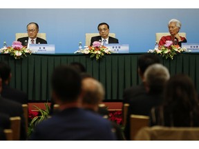Left to right; World Bank President Jim Yong Kim, Chinese Premier Li Keqiang, International Monetary Fund (IMF) Managing Director Christine Lagarde attend a news briefing after the Third Round Table Dialogue in Beijing, Tuesday, Nov. 6, 2018.