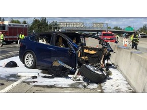 FILE - In this March 23, 2018 file photo provided by KTVU, emergency personnel work a the scene where a Tesla electric SUV crashed into a barrier on U.S. Highway 101 in Mountain View, Calif. The test results by AAA released Thursday, Nov. 15, 2018, come after several highly publicized crashes involving Tesla vehicles that were operating on the company's system named "Autopilot." The National Transportation Safety Board is investigating some of the crashes, including the March fatality that involved a Model X that struck a freeway barrier. (KTVU via AP, File)