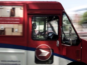 A Canada Post employee drives a mail truck through downtown Halifax on Wednesday, July 6, 2016.