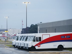 Canada Post Corp. mail delivery trucks sit in the Gateway Postal Facility parking lot in Toronto. Rotating strikes hit this plant for the second time in three weeks Tuesday.