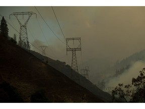 Power transmission lines crest a hilltop above Camp Creek Road, the point of origin of the Camp Fire, in Pulga, Calif., on Sunday, Nov. 11, 2018.