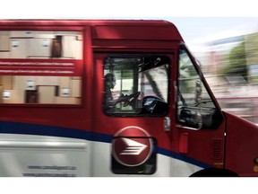 A Canada Post employee drives a mail truck through downtown Halifax on Wednesday, July 6, 2016.