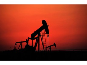 Oil pumps work at sunset on Sept. 11, 2013, in the desert oil fields of Sakhir, Bahrain.