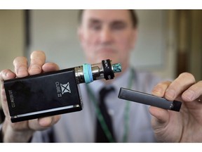 In this Tuesday, April 10, 2018 photo Marshfield High School Principal Robert Keuther displays vaping devices that were confiscated from students in such places as restrooms or hallways at the school in Marshfield, Mass. Juul Labs says it will continue selling its flavoured e-cigarette pods in Canadian convenience and vape shops, despite pulling some flavours from store shelves south of the border because they might appeal to young people.THE CANADIAN PRESS/AP/Steven Senne