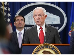 Attorney General Jeff Sessions speaks during a news conference to announce a criminal law enforcement action involving China, at the Department of Justice in Washington, Thursday, Nov. 1, 2018. Standing behind Sessions is Assistant Attorney General for National Security John C. Demers. The Justice Department and FBI leaders announced criminal charges and an operation to thwart Chinese economic espionage.