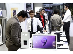 A customer looks at items at Samsung shop in an electronics shopping mall in downtown Tehran, Iran, Monday, Nov. 5, 2018. Iran greeted the re-imposition of U.S. sanctions on Monday with air defense drills and a statement from President Hassan Rouhani that the nation faces a "war situation," raising Mideast tensions as America's maximalist approach to the Islamic Republic takes hold.