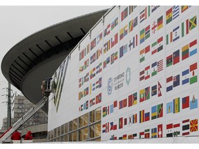In this Nov. 20, 2018 photo workers decorate the venue of the global climate summit that will be held at the site of the closed 'Katowice' coal mine in the city of Katowice, southern Poland, where - three years after sealing a landmark global climate deal in Paris - world leaders are gathering again to agree on the fine print.