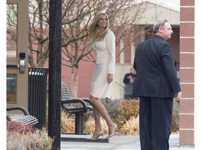 Ivanka Trump looks back at supports and protestors as she enters Wilder Elementary School in Wilder, Idaho, Tuesday, Nov. 27, 2018.  Ivanka Trump, President Donald Trump's daughter and White House adviser, and Apple CEO Tim Cook visited the heavily Hispanic Idaho school district Tuesday to trumpet her workforce development initiative promoting science, technology, engineering and math, White House officials said.