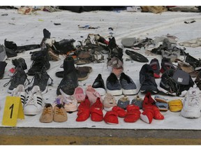 Shoes and other personal belongings retrieved from the waters where a Lion Air jet is believed to have crashed are displayed for family members of the passengers for identification at Tanjung Priok Port in Jakarta, Indonesia, Wednesday, Oct. 31, 2018. A massive search effort has identified the possible seabed location of the crashed Lion Air jet, Indonesia's military chief said Wednesday, as experts carried out the grim task of identifying dozens of body parts recovered from a 15-nautical-mile-wide search area.