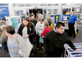 FILE- In this Nov. 23, 2017, file photo shoppers enter a Best Buy looking for early Black Friday deals on Thanksgiving Day in Bowling Green, Ky. A solid 70 percent of Americans plan to shop on Black Friday this year, according to a recent NerdWallet study conducted by The Harris Poll.