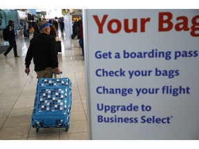 A traveler pulls luggage at Baltimore-Washington International Thurgood Marshall Airport, Tuesday, Nov. 20, 2018, in Linthicum, Md. Favorable weather is helping get the Thanksgiving travel rush off to a smooth start. By midday Tuesday, just a few dozen flights had been canceled around the U.S. That's fewer cancelations than many regular travel days.