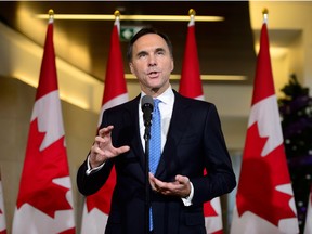 Finance Minister Bill Morneau holds a press conference in the media lockup for the fall economic update, in Ottawa on Wednesday, Nov. 21, 2018.