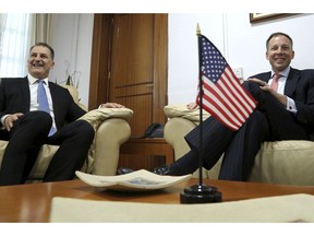 U.S. Assistant Secretary of State Francis Fannon, right, and Cyprus' Energy minister Yiorgos Lakkotrypis talk during their meeting at the Energy ministry in Nicosia, Cyprus, Friday, Nov. 16, 2018. Fannon visited Cyprus as part of a three-country tour in the region as ExxonMobil is ready to start exploratory drilling in waters southwest of Cyprus.