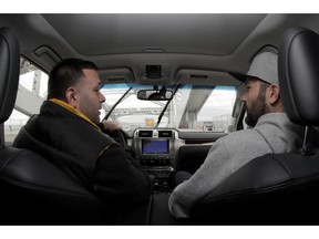 In a photo take Friday, Nov. 9, 2018, Lenny Sciascia, left, talks with his friend Mario DeAngelis as they cross the Bayonne Bridge in Bayonne, N.J., on their way to place online bets on their smartphones in New Jersey. Sciascia, who lives in Staten Island, N.Y., commutes regularly to places his bets from New Jersey, where online betting is legal. With sports betting being advertised all around them but the opportunity to actually do it restricted to just one nearby state, gamblers from New York and Pennsylvania are crossing bridges and tunnels into New Jersey to make legal sports bets.