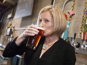 Alberta Premier Rachel Notley drinks a beer while touring the Cold Garden Beverage Company in Calgary on March 27, 2017.