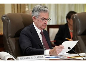 FILE- In this Oct. 31, 2018, file photo Federal Reserve Chair Jerome Powell looks over papers as the Federal Reserve Board holds a meeting at the Marriner S. Eccles Federal Reserve Board Building in Washington. With the economy strong, wages rising and unemployment at a near-five-decade low, the Federal Reserve remains on track to keep raising interest rates, just not this week. After the Fed's latest policy meeting, it's expected to signal a healthy outlook for the economy but to hold off on any further credit tightening, most likely until December. A rate hike in December would mark the fourth this year.