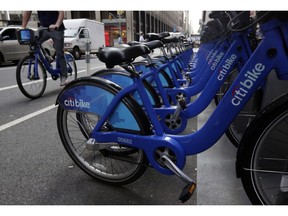 FILE- In this July 22, 2014, file photo parked Citi Bikes line a street in New York. Ride-share companies are capitalizing on voter enthusiasm ahead of Tuesday's midterm elections by offering free or discounted rides to the polls in shared cars or on bikes. Bike share company Motivate, which operates Citi Bike, is offering free bike rides.