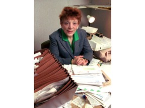 FILE- In this April 1990 file photo Evelyn Y. Davis, 60, poses for a photo in her Watergate Office Complex Suite in Washington. Davis, who owned stock in more than 80 public companies and liked to make a show of her presence at shareholder meetings, died Sunday, Nov. 4, 2018. She was 89.