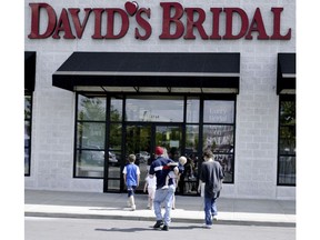 FILE- In this May 10, 2005, file photo shoppers head for David's Bridal in Sunset Hill, Mo. David's Bridal is filing for bankruptcy protection, though it says there is no danger for customers who have ordered dresses, and operations will continue as before as the company restructures. The retailer said Monday, Nov. 19, that the expected move will wipe out more than $400 million in long-term debt.
