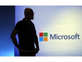 FILE- In this May 7, 2018, file photo Microsoft CEO Satya Nadella looks on during a video as he delivers the keynote address at Build, the company's annual conference for software developers in Seattle. Microsoft is threatening to overtake Apple as the world's most valuable publicly traded company. The market closed Tuesday, Nov. 27, with Microsoft just behind Apple.