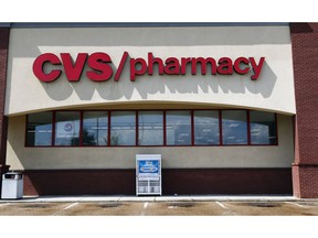 FILE- In this Aug. 7, 2018, file photo a CVS Pharmacy building sign rests on a Jackson, Miss., store. CVS Health Corp. reports earnings Tuesday, Nov. 6.