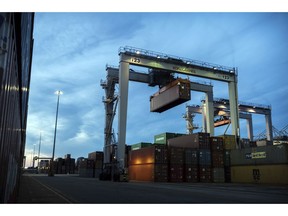 FILE- In this July 5, 2018, file photo, a rubber tire gantry moves a shipping container in the container yard at the Port of Savannah in Savannah, Ga. On Friday, Nov. 2, the Commerce Department reports on the U.S. trade gap for September.