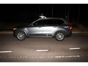 FILE - This file photo provided by the Tempe Police Department shows an Uber SUV after hitting a woman on March 18, 2018, in Tempe, Ariz.  Nearly eight months after one of its autonomous test vehicles hit and killed an Arizona pedestrian, Uber wants to resume testing on public roads. The company has filed an application with the Pennsylvania Department of Transportation to test in Pittsburgh, and it has issued a lengthy safety report pledging to put two human backup drivers in each vehicle and take a raft of other precautions to make the vehicles safe. Company officials acknowledge they have a long way to go to regain public trust after the March 18 crash in Tempe, Arizona, that killed Elaine Herzberg, as she crossed a darkened road outside the lines of a crosswalk. (Tempe Police Department via AP, File)