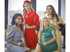 In this Nov. 5, 2018 photo, designer Katie Echeverry, seated right, join models Tiffany Hendrix, seated left, Kelsey Elliott, standing left, and Lori Moran, wearing outfits from a Barbie inspired fashion line she created in collaboration with toy company Mattel in New York. The collaboration, Barbie x Unique Vintage, is sold online at uniquevintage.com and in about 500 boutiques around the world.