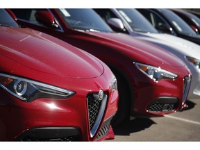 FILE- In this Oct. 21, 2018, file photo a long line of unsold 2018 Stelvio sports-utility vehicles sits at an Alfa Romeo dealership in Highlands Ranch, Colo. On Wednesday, Nov. 21, the Commerce Department releases its October report on durable goods.