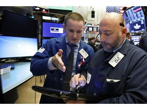 Specialist Stephen Naughton, left, and trader Vincent Napolitano work on the floor of the New York Stock Exchange, Friday, Nov. 9, 2018. Stocks are falling as energy companies are dragged lower by the continuing plunge in crude oil prices.