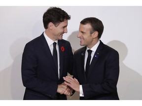 French President Emmanuel Macron, right, meets Canadian Prime Minister Justin Trudeau at the Paris Peace Forum in Paris, Sunday, Nov.11, 2018. International leaders attended a ceremony in Paris on Sunday at mark the 100th anniversary of the end of World War I.