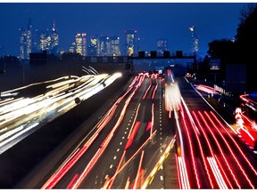 This long exposure picture shows cars driving on the highway with the Banking district in background in Frankfurt, Germany, Thursday, Nov. 1, 2018.