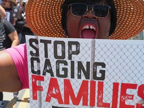 Protesters outside the Otay Mesa Detention Center in San Diego, California. The centre is owned and operated by private prison company CoreCivic.