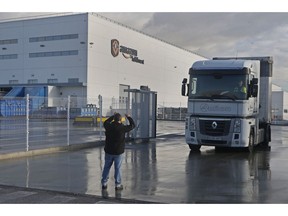 A picket stops a truck to speak with the driver leaving the main Amazon Logistics Center where goods are stored for distribution, on the outskirts of Madrid, Spain, Friday Nov. 22, 2018. Amazon workers are staging a 2-day strike coinciding with Black Friday over a labour dispute.