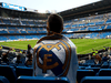 A fan waits the start of a Real Madrid match. The football club has a unique corporate structure that some argue adds to its global appeal.