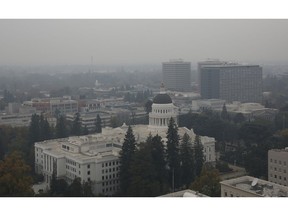 The California state Capitol is viewed through the smoke from the Camp Fire, Tuesday, Nov. 13, 2018, in Sacramento, Calif. Smoke from the Camp Fire, which has been burning since last Thursday nearly 90 miles north of Sacramento, has blanketed much of Northern California. The fire has destroyed thousands of homes and killed dozens of people.