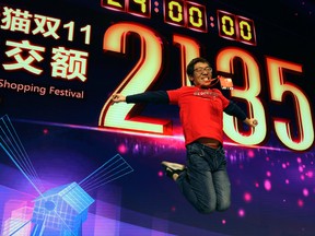 A staff member celebrates after Alibaba's Singles Day sets a new record of RMB213.5 billion or more than US$30 billion in Shanghai, China, Monday.