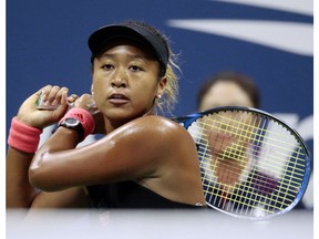 FILE - In this Sept. 8, 2018, file photo, Naomi Osaka, of Japan, returns a shot to Serena Williams fo the U.S. during the women's final of the U.S. Open tennis tournament, in New York. Osaka is headed for big money with both Japanese and global appeal. Among companies vying to cash in on her stardom is Tokyo-based Citizen Watch Co. Its 80,000 yen ($700) Naomi Osaka watch is selling out after it got a lot of exposure on her wrist at the U.S. Open, where she beat Williams.