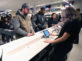 Customers queue to pay for legal cannabis at Tokyo Smoke in Winnipeg. The chain which is owned by Canopy Growth may not be able to operate in Ontario.