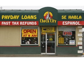This undated photo shows a sign for Check City, which offers payday loans, in Salt Lake City. Americans take out roughly $50 billion in payday loans a year, each racking up hundreds of dollars in fees and interest.