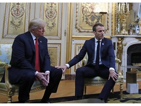 In this Nov. 10, 2018, file photo, French President Emmanuel Macron touches the knee of President Donald Trump during their meeting inside the Elysee Palace in Paris Saturday Nov. 10, 2018.